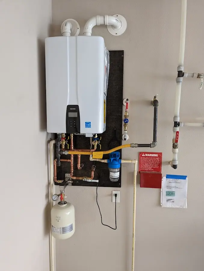 Professional plumber installing copper piping in a Cherokee home